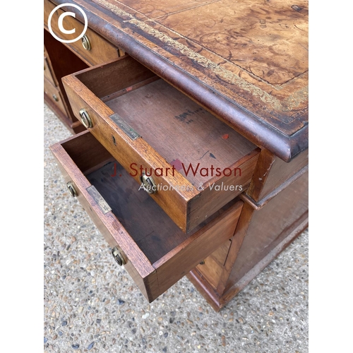 96 - A victorian mahogany pedestal desk with a gold leather top 152x79x77