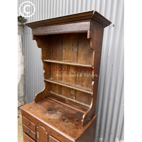 97 - An early oak dresser base (cut to two section) with later oak platerack top