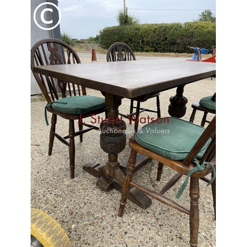 98 - An oak refectory style table together with four wheelback chairs