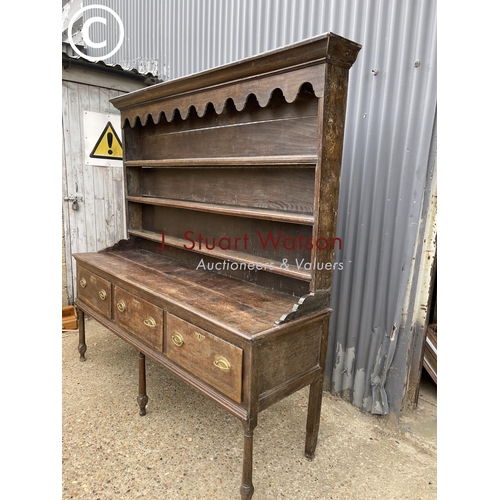 99 - An early oak three drawer dresser with plate rack top 187cm wide