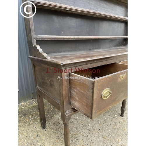 99 - An early oak three drawer dresser with plate rack top 187cm wide