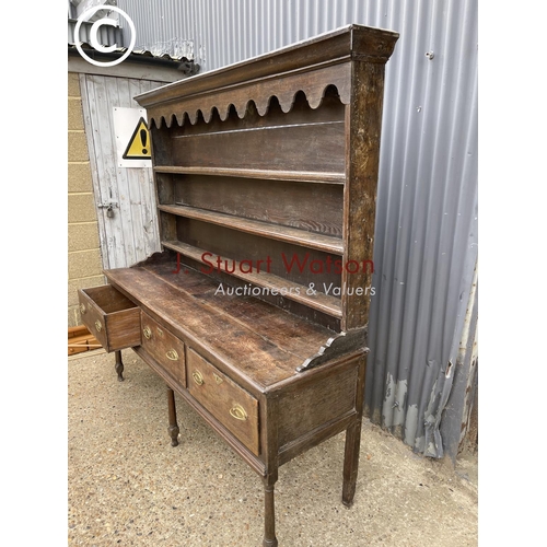 99 - An early oak three drawer dresser with plate rack top 187cm wide