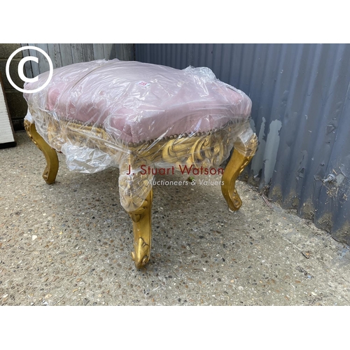 312 - A gold gilt footstool upholstered in soft pink