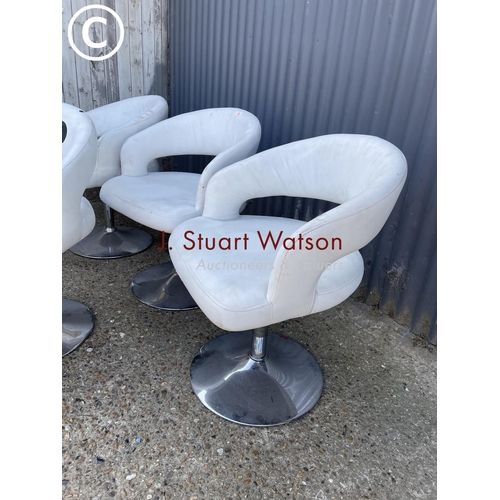 329 - A set of four white vinyl swivel chairs on chrome bases