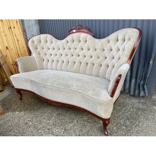 1 - A reproduction mahogany framed chaise settee with beige buttoned upholstery