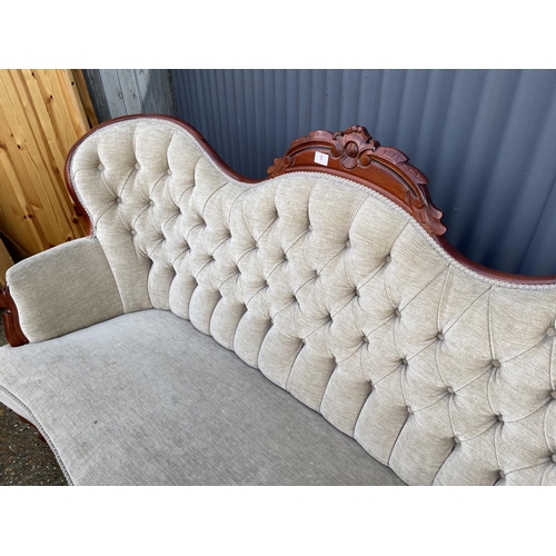 1 - A reproduction mahogany framed chaise settee with beige buttoned upholstery