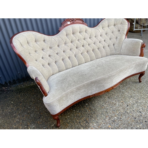 1 - A reproduction mahogany framed chaise settee with beige buttoned upholstery