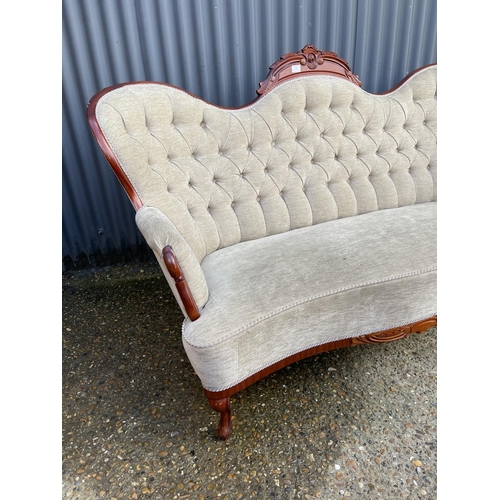 1 - A reproduction mahogany framed chaise settee with beige buttoned upholstery