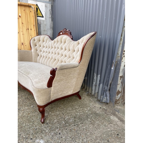 1 - A reproduction mahogany framed chaise settee with beige buttoned upholstery