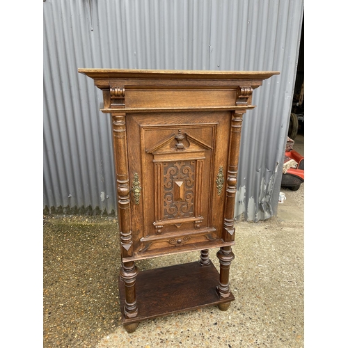 11 - A continental oak cupboard fitted with shelves to interior  80x45 x 134