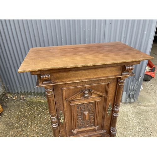 11 - A continental oak cupboard fitted with shelves to interior  80x45 x 134