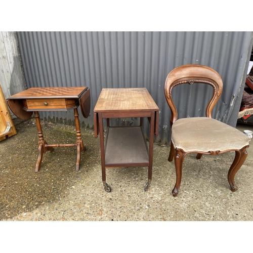 12 - A mid century teak trolley, a chequered top games table and a balloon back chair