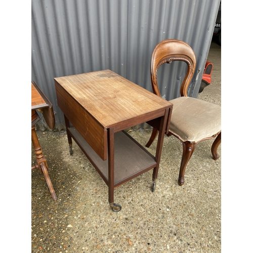 12 - A mid century teak trolley, a chequered top games table and a balloon back chair