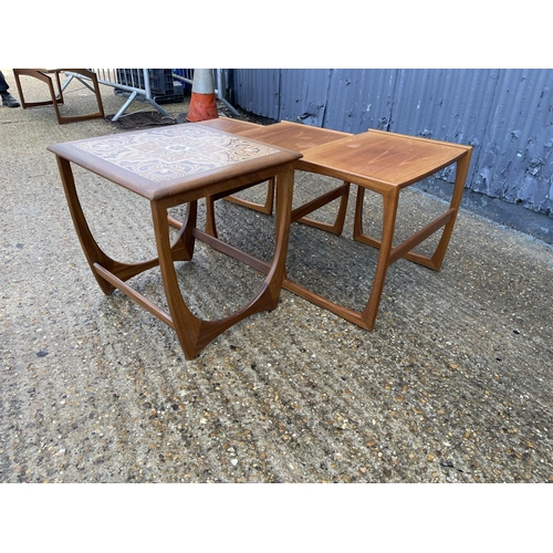 131 - A teak nest of three together with a g plan tile top table