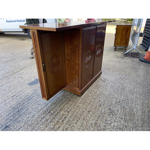 133 - An oriemtal style hardwood bar with fold over top and ornate  cocktail and drinks storage compartmen... 