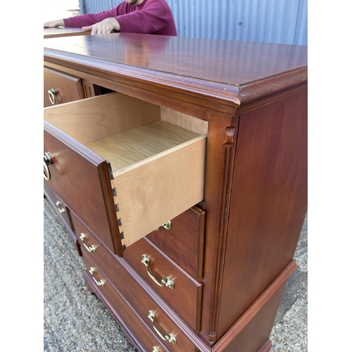 135 - A hardwood tallboy chest of drawers stamped MADE IN USA 95x40x147