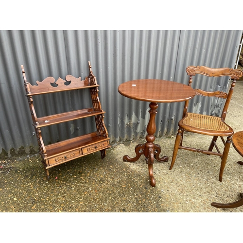 15 - A mahogany occasional table, wall shelf, begere chair and two oval occasional tables