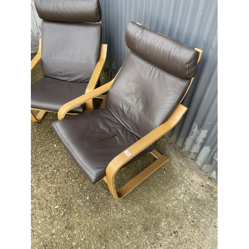 172 - A pair of modern cantilever armchairs with brown leather upholstery