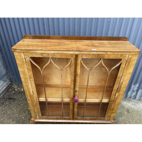 175 - An early 20th century walnut display cabinet