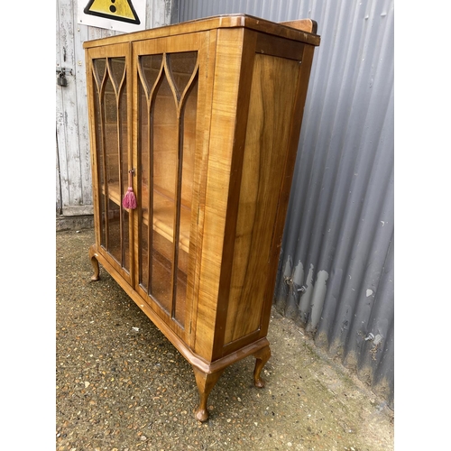 175 - An early 20th century walnut display cabinet