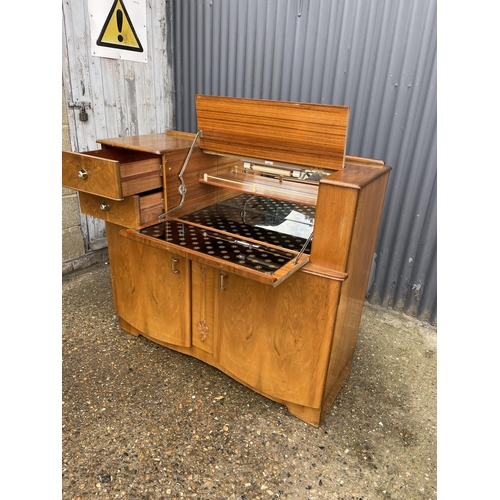 177 - A deco style walnut cocktail sideboard with mirror glass interior