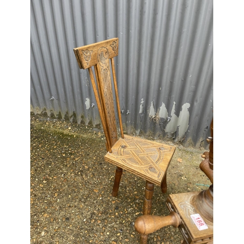 188 - A carved spinning wheel with matching chair