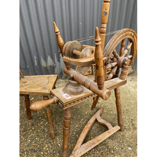 188 - A carved spinning wheel with matching chair