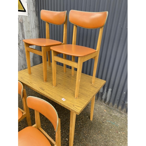 195 - A vintage formica kitchen table with four chairs