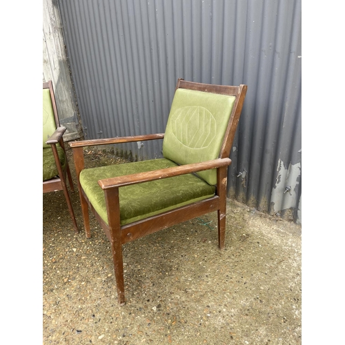 196 - A pair of teak framed green mid century Italian elbow chairs