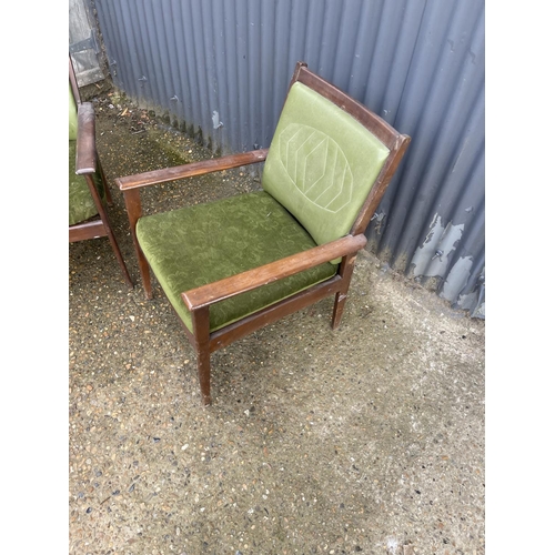 196 - A pair of teak framed green mid century Italian elbow chairs