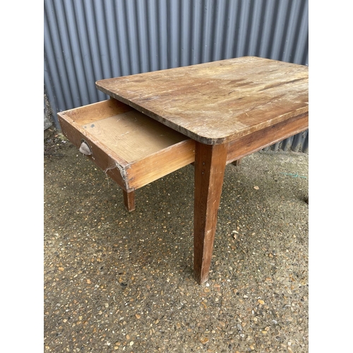 203 - A rustic pine kitchen table with drawer