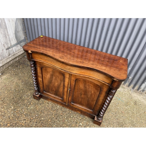 204 - A victorian mahogany serpentine front sideboard