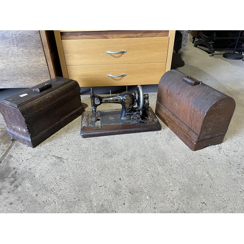 215 - Two oak cased sewing machines