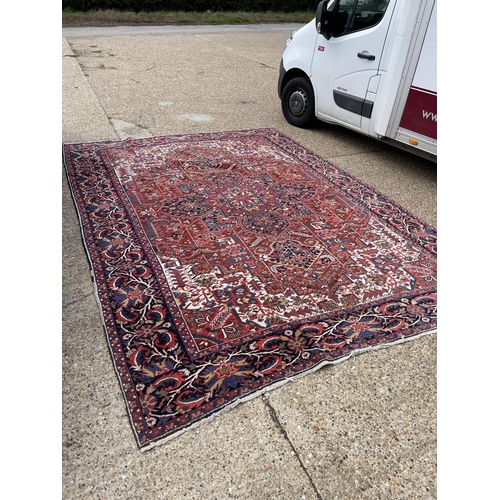 22 - A fine quality Heriz red, blue and white pattern carpet 404x290 cms