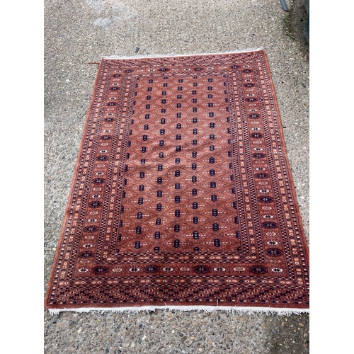 23 - A red oriental pattern rug