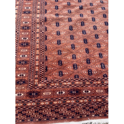 23 - A red oriental pattern rug