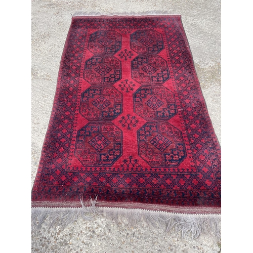 24 - A red oriental pattern rug 250x150