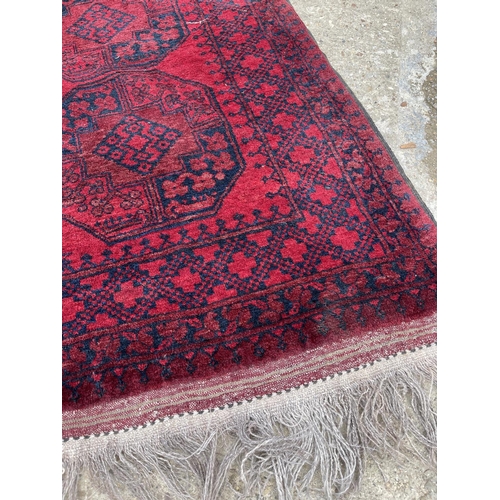 24 - A red oriental pattern rug 250x150