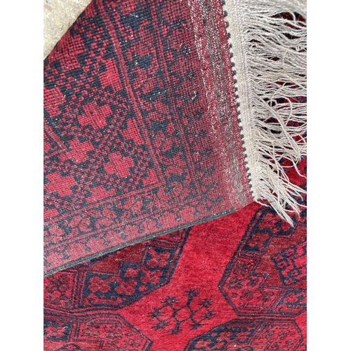 24 - A red oriental pattern rug 250x150