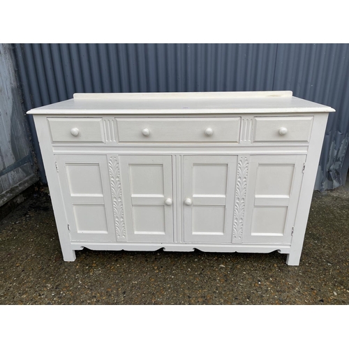 251 - A white painted oak three drawer sideboard