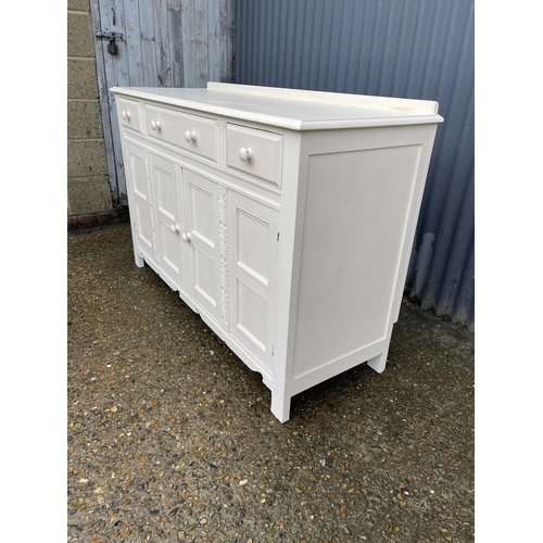 251 - A white painted oak three drawer sideboard