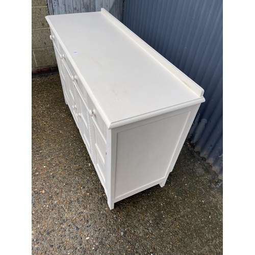 251 - A white painted oak three drawer sideboard