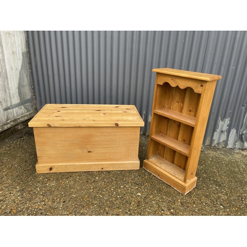 257 - A solid pine blanket box chest together with a slim pine bookcase