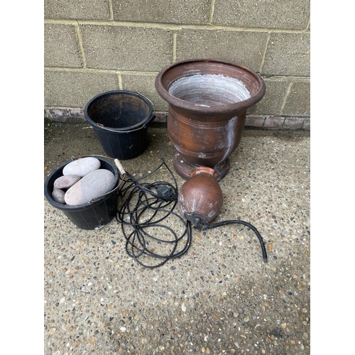 27 - A water feature garden urn with pump and decorative stones