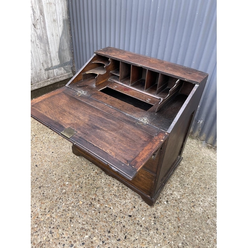 282 - A Georgian oak bureau, fitted to the interior with well. Three drawers