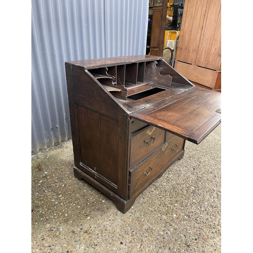 282 - A Georgian oak bureau, fitted to the interior with well. Three drawers