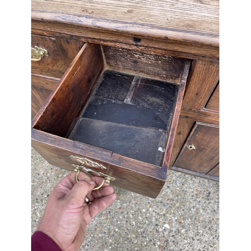 283 - An oak sideboard with three drawers over three cupboard doors 130x40x110