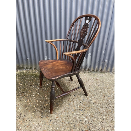 284 - An antique elm wheelback carver chair