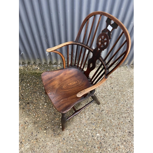 284 - An antique elm wheelback carver chair