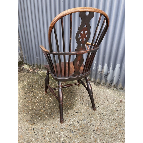 284 - An antique elm wheelback carver chair